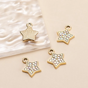 Detail showing gold plated star pendants with colorful zircon inlay and vertical texture