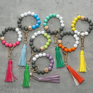 Colorful silicone and wooden bead bracelet keyrings with leather tassels and gold clips