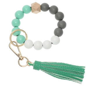 Detail of colorful wooden bead keychain bracelet with PU leather tassel and gold clasp