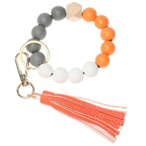 Close-up of colorful wooden beads keychain wristlet with orange PU leather tassel and ring