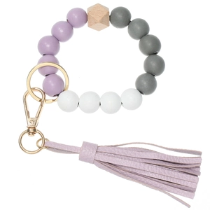 Detail of round silicone beads and hexagonal wood bead with purple leather tassel
