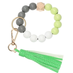 Detail view of beaded keychain bracelet with grey silicone beads and green leather tassel