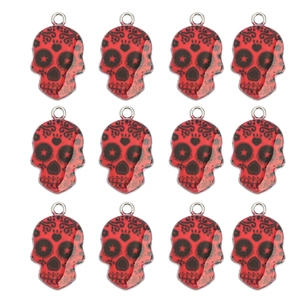 Detailed macro view of 12 red skull pendants with black graffiti and silver metal loops