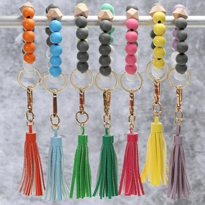 Detail view of colorful beaded keychain wristlets with wooden beads and leather tassels