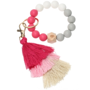 Detailed shot of silicone beaded keychain with wooden evil eye charm and layered tassel