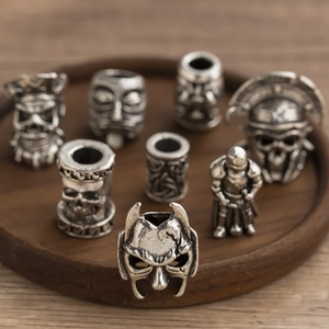 Vintage silver alloy beads featuring skull and medieval helmet designs for DIY jewelry
