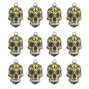Detailed set of twelve yellow enamel skull charms with black floral patterns for DIY jewelry