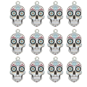 Set of 12 colorful Day of the Dead skull charms with floral enamel patterns for DIY jewelry
