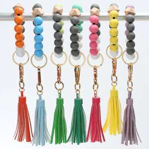 Detailed view of colorful silicone beaded keychain bracelets with leather tassels