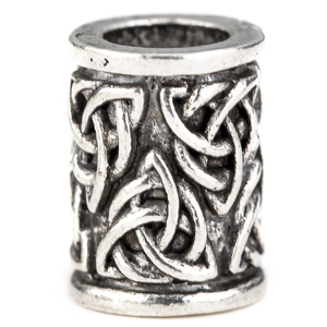 Macro view of vintage silver Viking beard beads with Celtic knot textured relief patterns