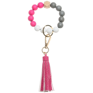 Detail of pink and grey silicone beaded bracelet keychain with pink leather tassel
