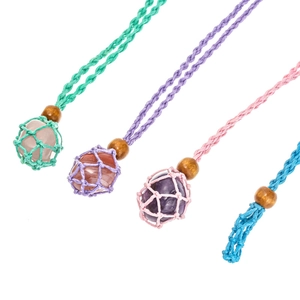 Detail view of handmade woven rope necklaces with natural stone nets in four colors