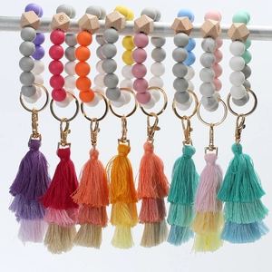 Detailed view of colorful silicone bead keychains with wooden accents and silk tassels