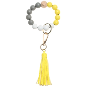 Detail of wooden beads, leather tassel, and golden clasp on the keychain bracelet