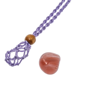 Macro detail of handmade purple cord necklace with wooden bead and stone mesh pouch