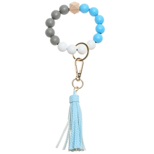 Detail of round wooden beads and blue leather tassel with gold metal keyring