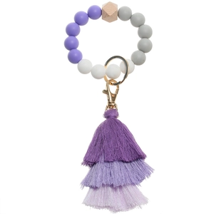 Close-up of silicone beaded keychain with purple gradient tassel and gold lobster clasp