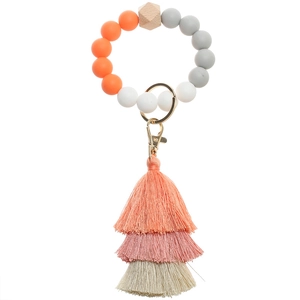 Macro detail of silicone beaded keychain with multi-layer tassel and wooden bead