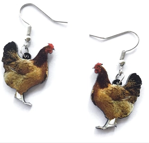 Close-up detail of creative acrylic hen earrings with colorful chicken pattern printing