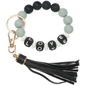 Detail of LOVE letter bead silicone bracelet keychain with black leather tassel and gold ring