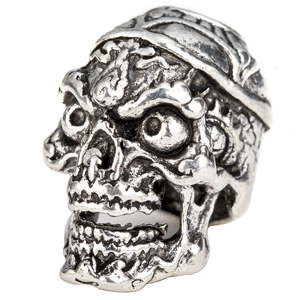 Macro shot of vintage silver skull bead featuring detailed engravings for hair or jewelry