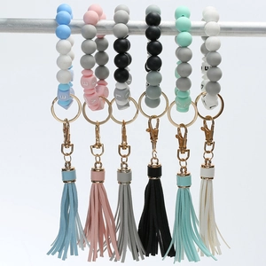 Detail of silicone bead bracelets with LOVE letters and tassels in six different colors