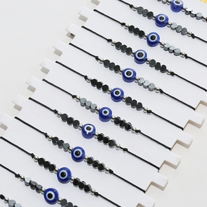 Détail de bracelets mauvais œil ajustables avec perles bleues et breloques cœur
