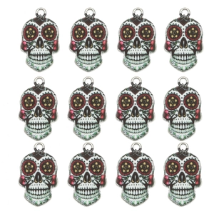 Detail of 12 sugar skull pendants with colorful floral patterns and silver alloy edges