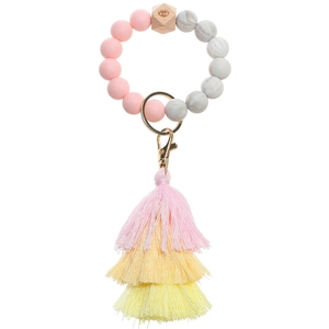 Detail of pink marble silicone bead keychain featuring a tassel and engraved wooden bead