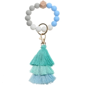 Detail view of silicone bead keychain with triple-layered tassel and golden metal clasp