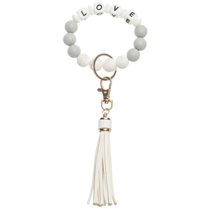 Detail of beaded keychain bracelet with LOVE letter beads and white leather tassel