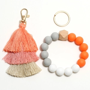 Detail of colorful silicone beaded keychain with multi-layer tassel and gold ring