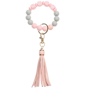 Close-up of LOVE letter beads with pink silicone beads and matching leather tassel keychain