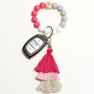 Detailed view of silicone bead keychain with layered tassels and engraved wood bead