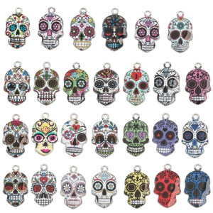 Macro display of 28 colorful Mexican sugar skull charms for DIY jewelry making