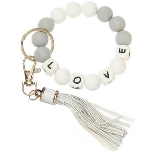 Detail of silicone bead keychain bracelet with LOVE letter cubes and white leather tassel