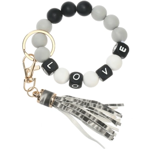 Detail of LOVE letter silicone beads on keychain with grey leather tassel and gold clasp