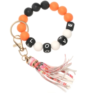 Close-up of silicone bead keychain featuring LOVE letter beads and striped tassel charm