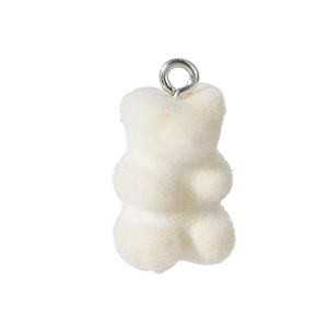 Macro shot of white flocked mini bear pendant with silver ring for DIY jewelry making