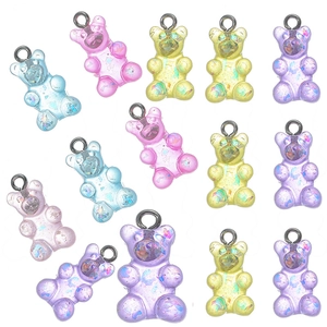 Colorful resin bear pendants with glitter sequins and silver loops set on white background