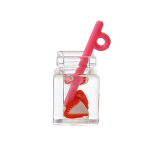 Macro shot of miniature resin strawberry juice bottle with straw for DIY crafts