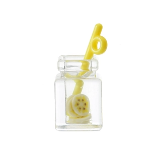 Macro shot of a mini resin fruit tea pendant with lemon slices and a yellow straw