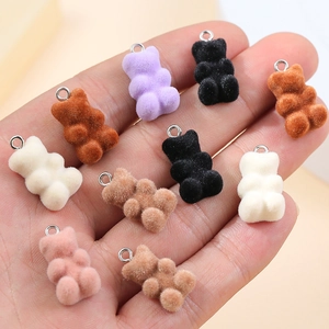 Macro detail of multi-colored flocked mini bear pendants for DIY jewelry making