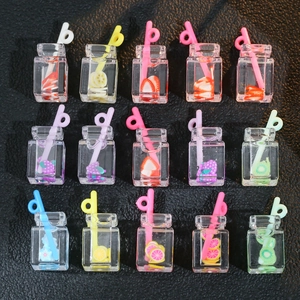 Mini resin fruit tea bottle charms with colorful straws on black leather background