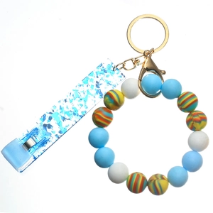 Detail of colorful silicone beaded keychain with golden lobster clasp and blue acrylic clip
