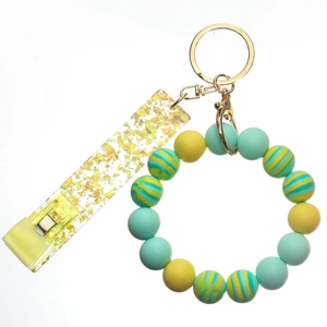 Detail of silicone beaded wristlet keychain with mint green beads and card holder clip