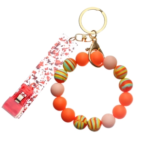 Detail of colorful silicone beaded keychain with glittery card grabber for long nails