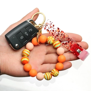 Silicone bead wristlet keychain with orange stripes and red sequin card holder clip