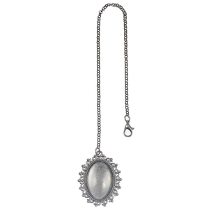Detailed macro view of vintage silver alloy oval photo locket with filigree edges