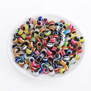 Close-up of colorful resin evil eye beads with stripe patterns for DIY jewelry making